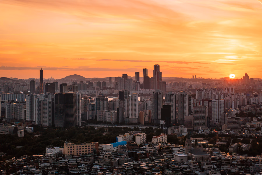 The skyline of Seoul glowing a warm orange color during sunset