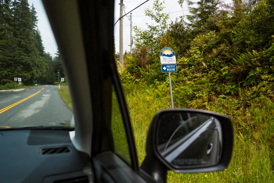 A highway sign for the Pacific Marine Circle Route is framed through a car window