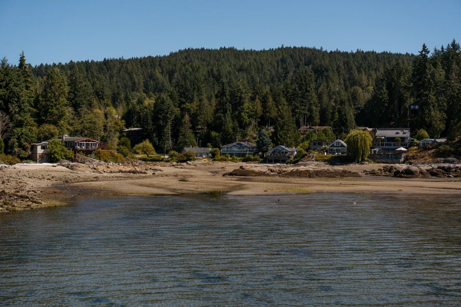 Row of sea side cottages near a dry Halfmoon Bay at low tide near Sechelt, BC