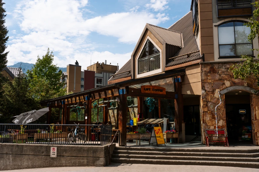 The large outdoor patio of Lift Coffee Company right off the Whistler Village Stroll on a clear summer day