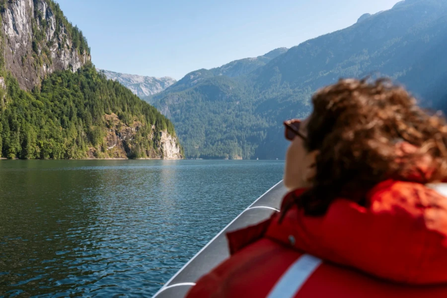 woman out of focus riding a zodiac boat through Princess Louisa Inlet