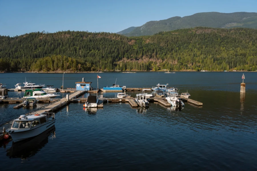 Several motor boats docked along a wooden dock in Egmont Harbour