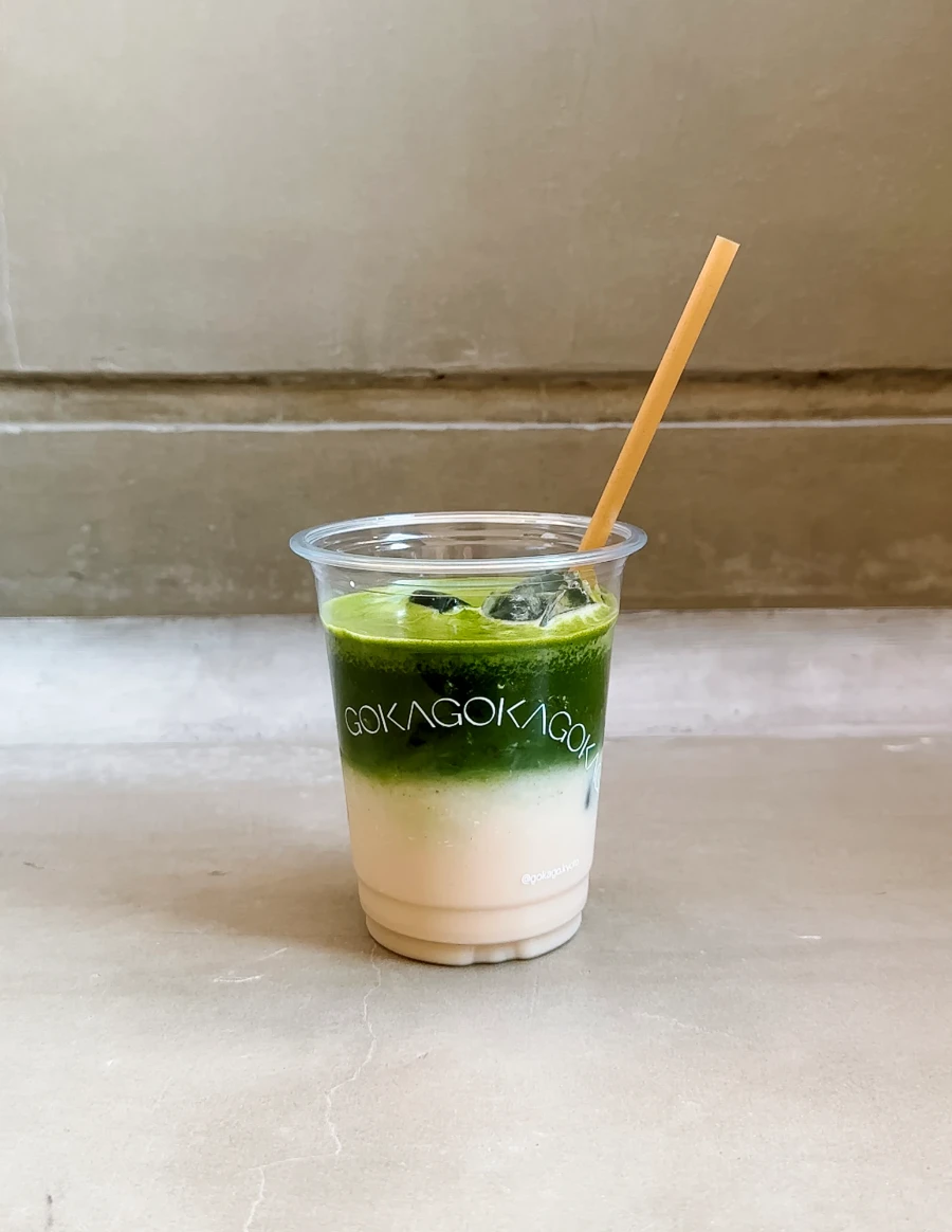 Mix of milk and matcha seperated in a plastic cup