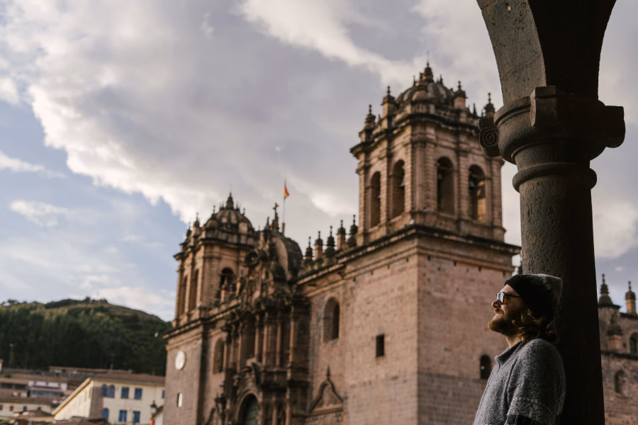 9 Best Things to Do in Cusco: man stands in Plaza De Armas