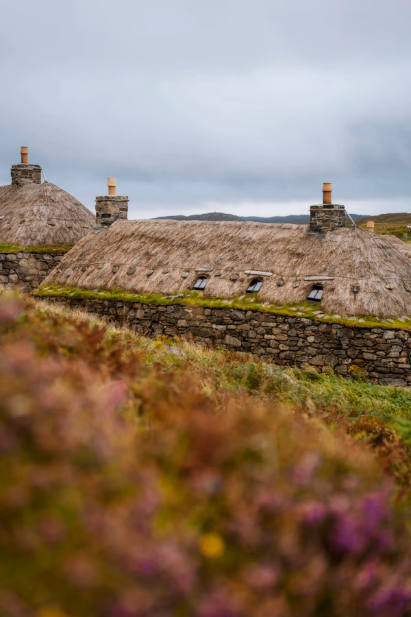 Thatched roof stone buildings on a cloudy day