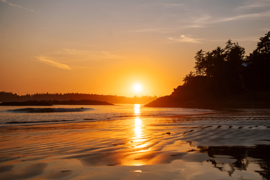 Sunset light being reflected in the wet sand at Tin Wis Beach in Tofino, BC