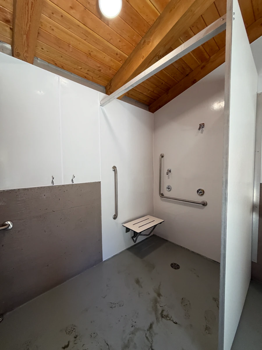 A clean and white open room, camp-style shower at China Beach Campground near Jordan River