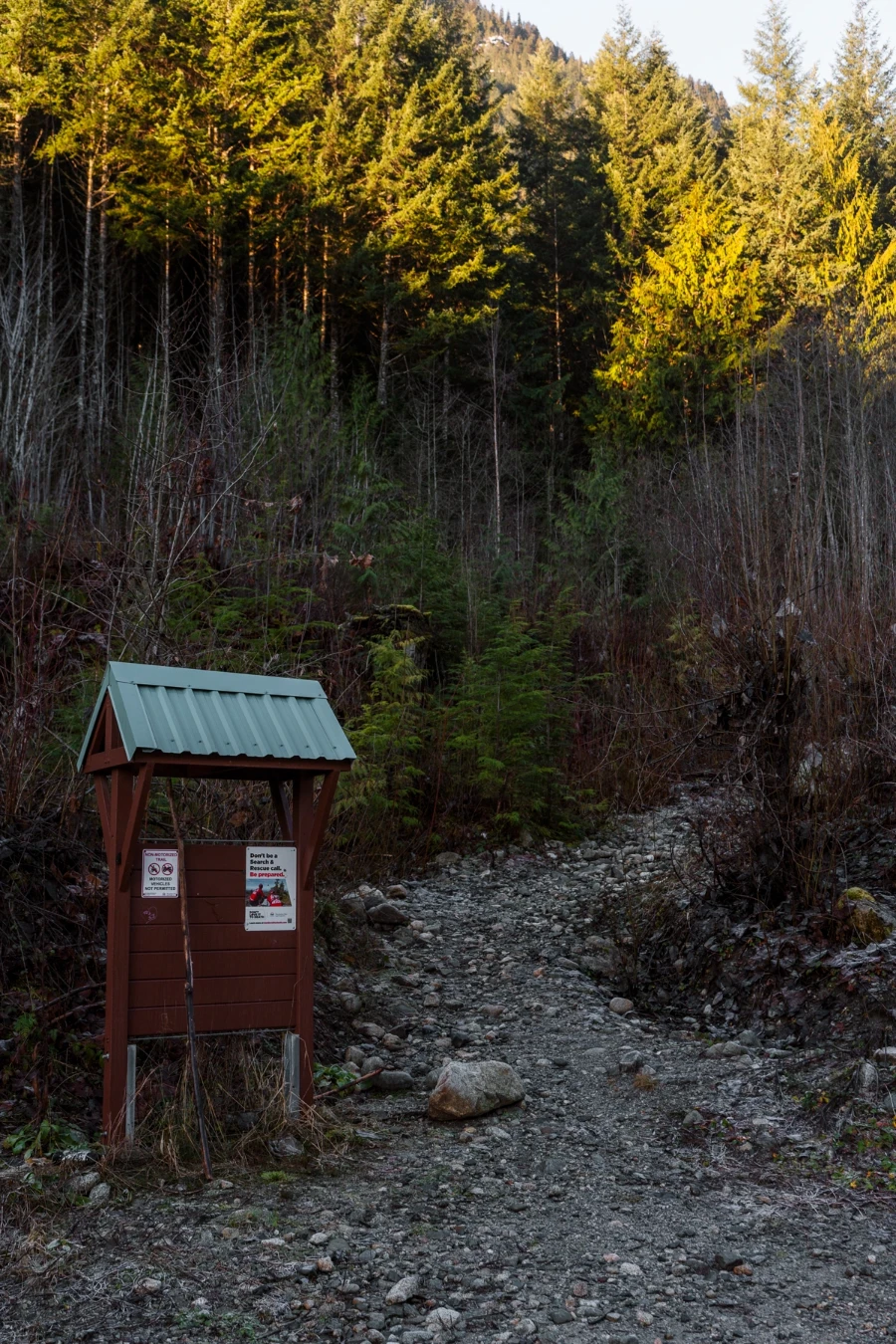 Small bulletin board at the based of a stony inclined path at the Crooked Falls Trailhead