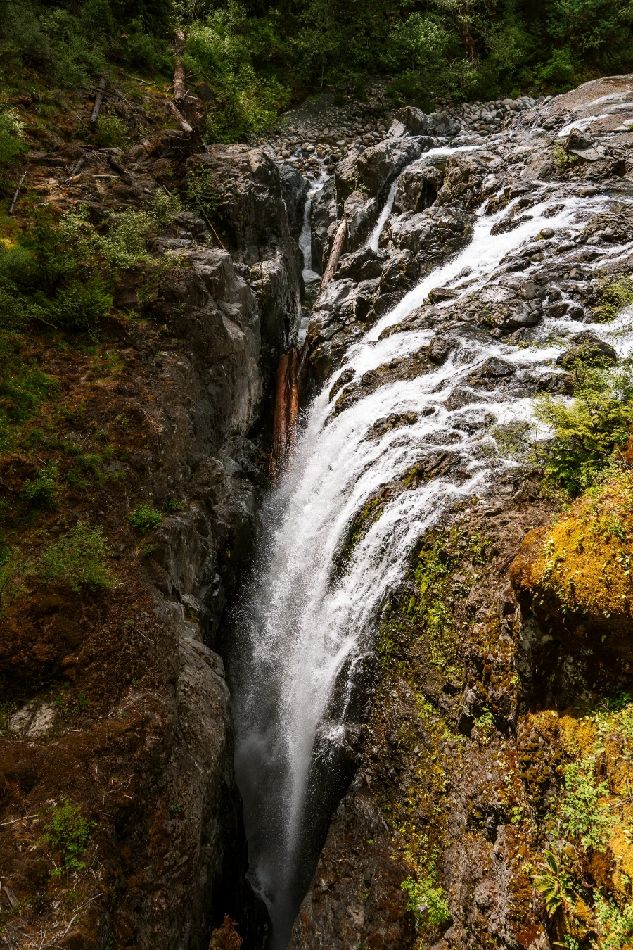A powerful waterfall collects dozens of streams before pouring off a steep cliff into a narrow channel