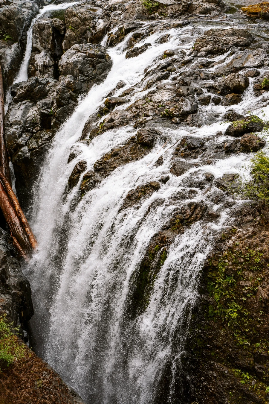 A powerful waterfall collects dozens of streams before pouring off a steep cliff into a narrow channel