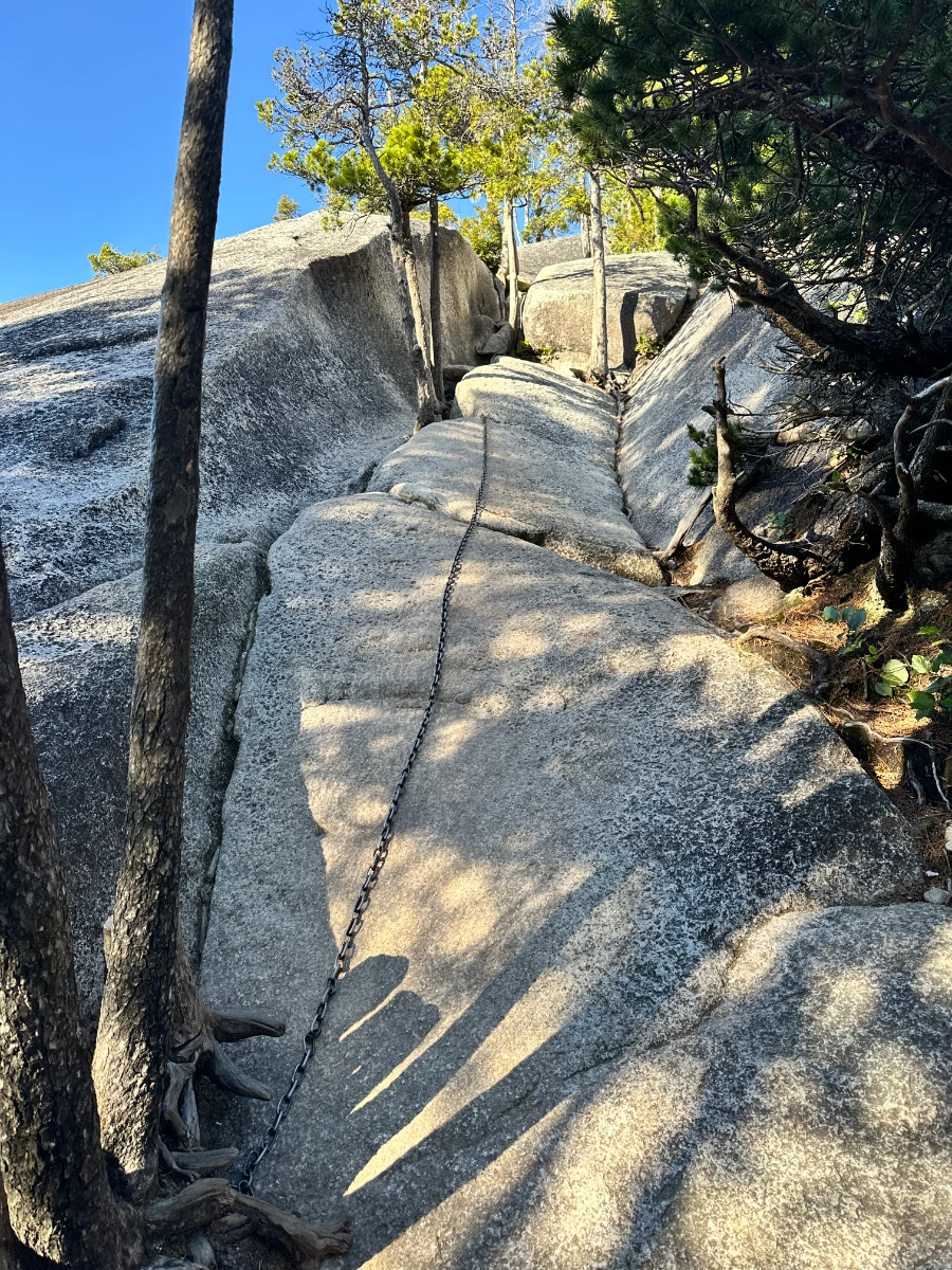 Several chains bolted into a steep granite slab near the peak of the Stawamus Chief