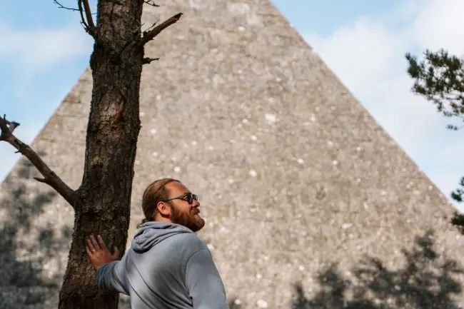 A man stands in front of Prince Albert's Cairn in Scotland