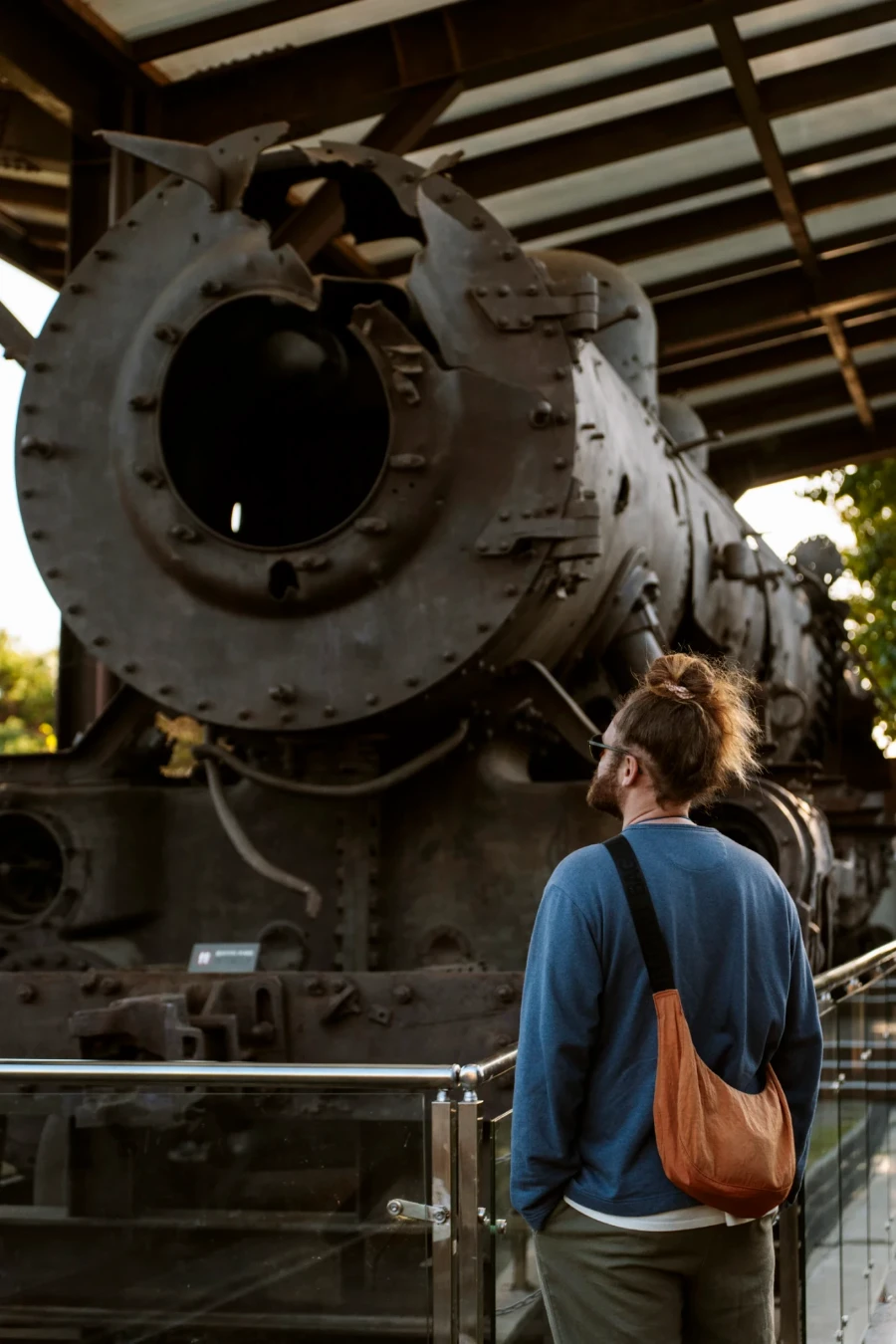 Man stands in front of an old not operating train at Dorasan Station in South Korea