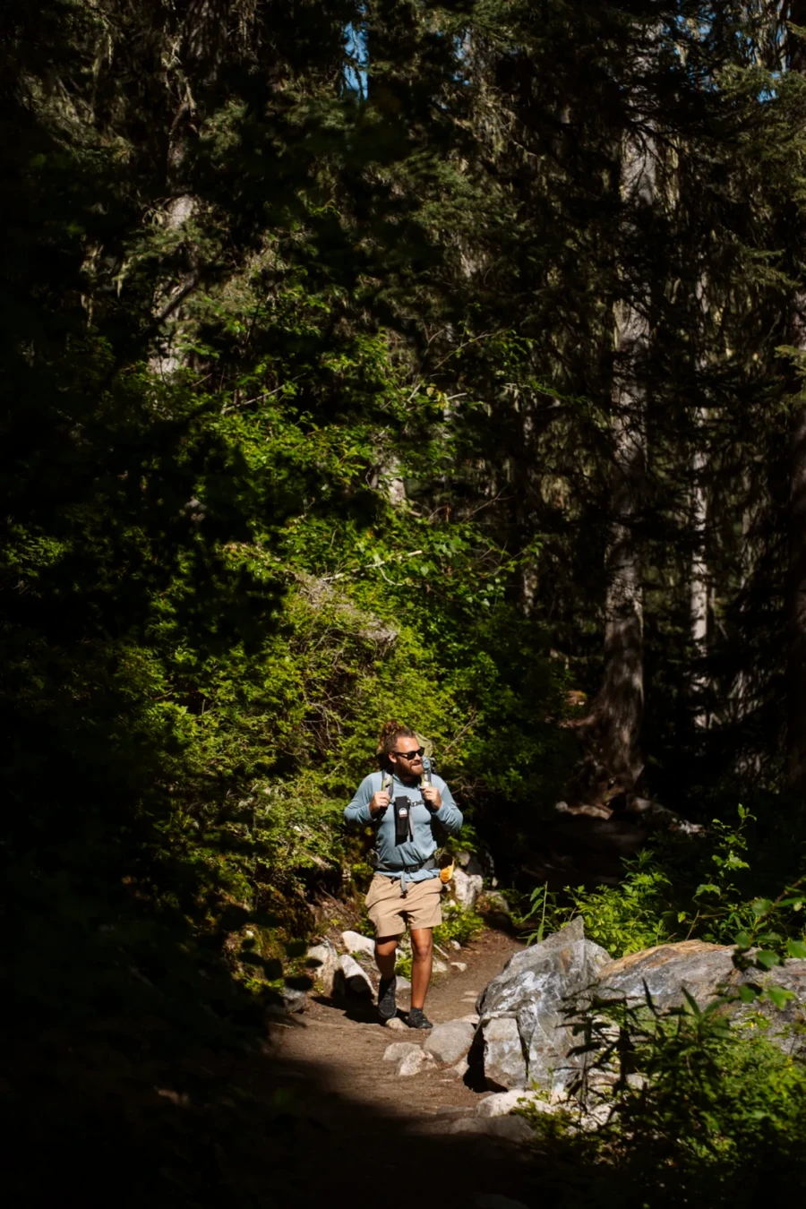 man walking up an inclined dirt path