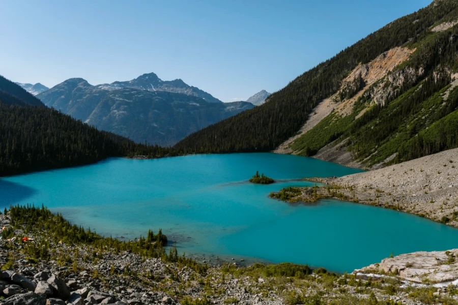 Upper Joffre Lake surrounded by trees and rockfalls