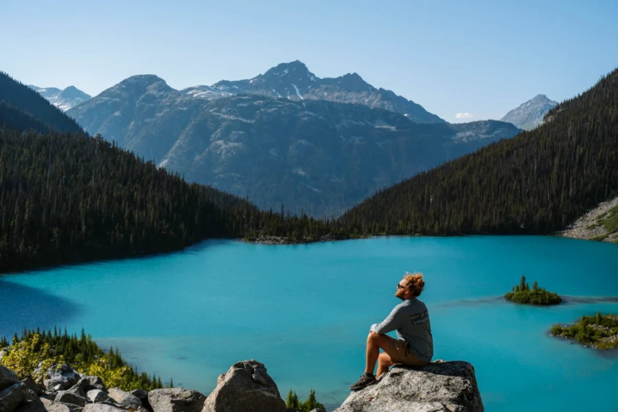 man siting on a rock above Upper Joffre Lake