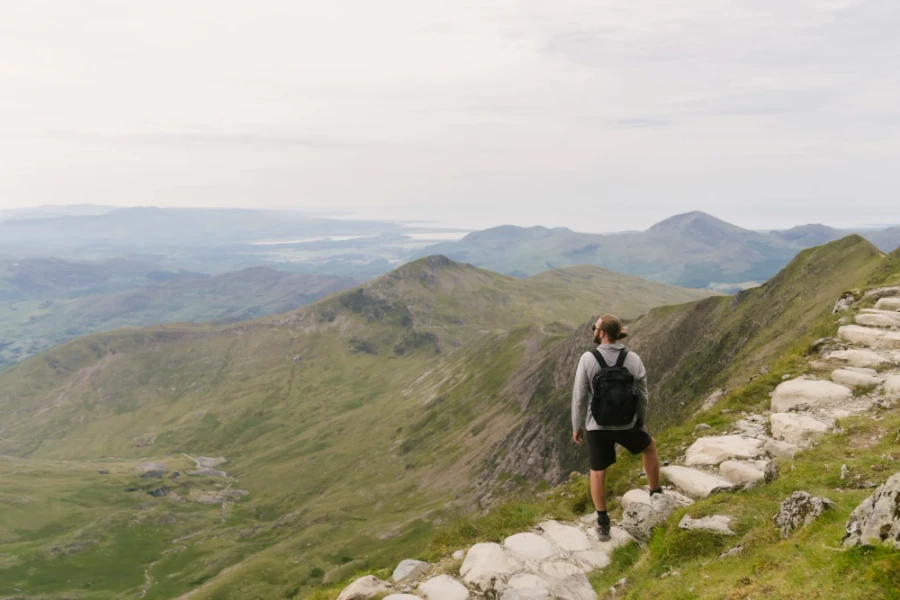 A Man Looks Out From The Stairs Near the Peak of Mount Snowdon