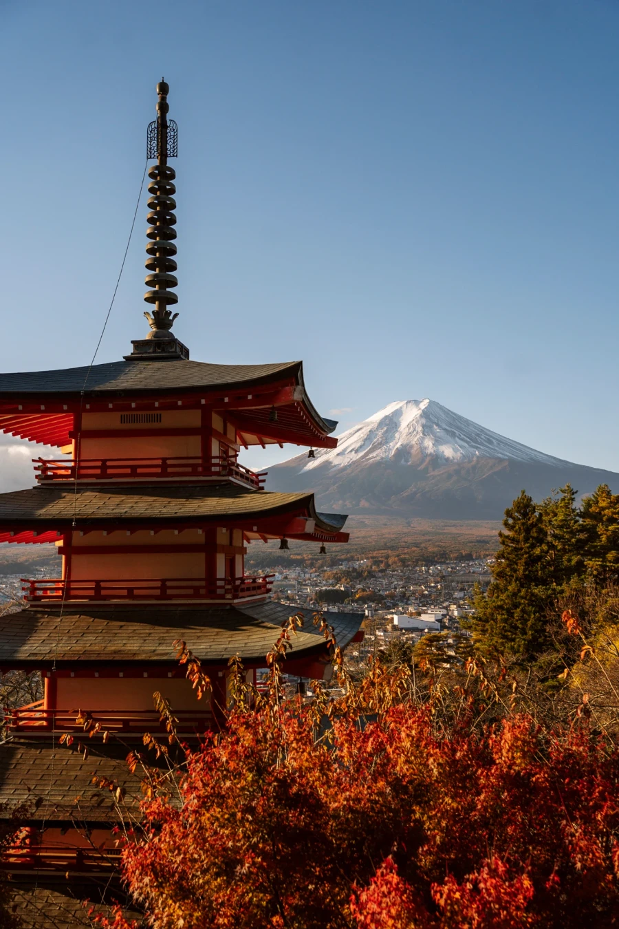 A five story pagoda known as the Chureito Pagoda (Sunrise Spot) frames the snow capped peak of mt Fuji at sunrise