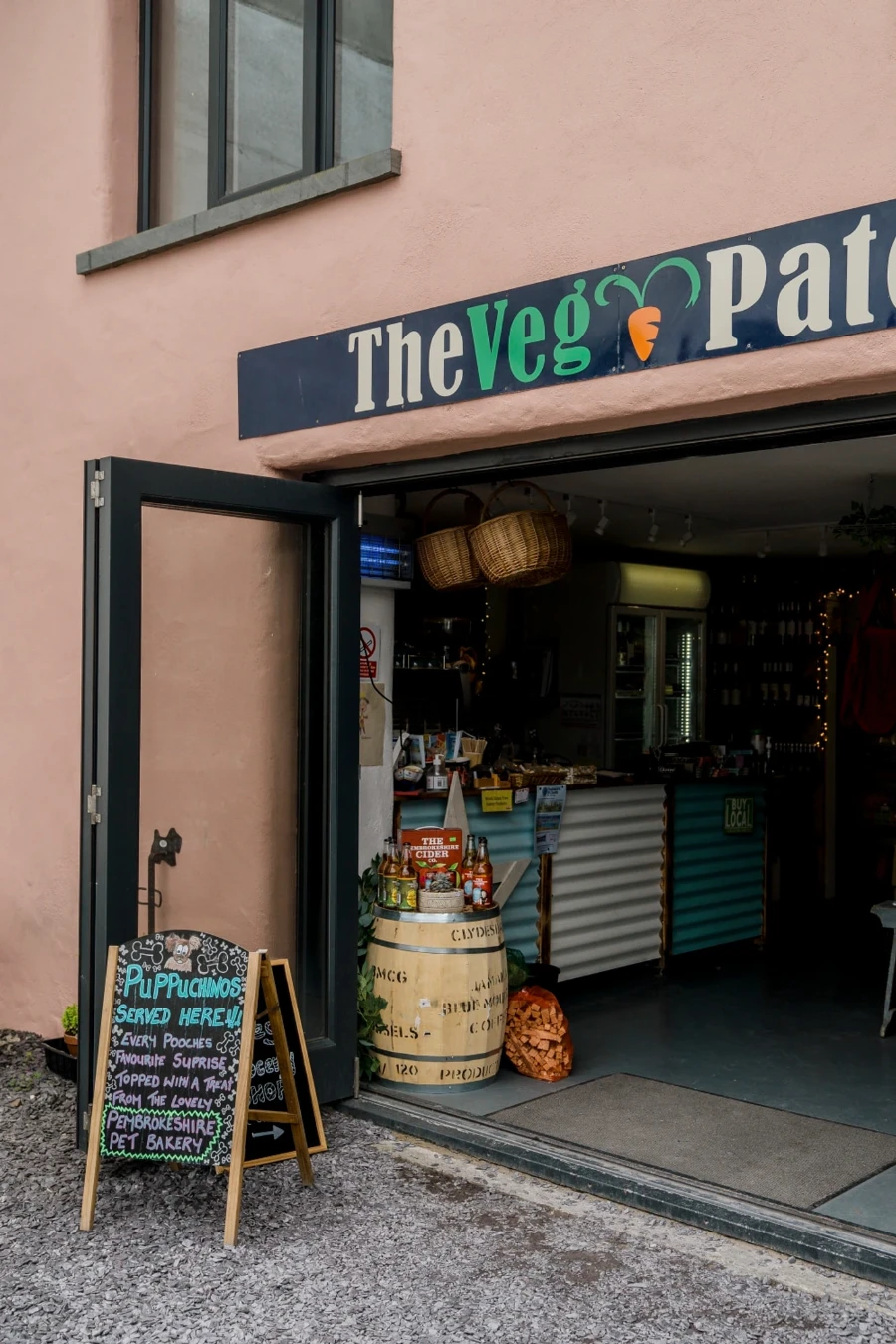 A storefront with a chalkboard sign advertising puppichinos