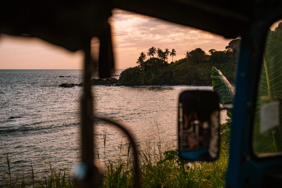 A coastal sunset through the window of a tuktuk on the south coast of Sri Lanka