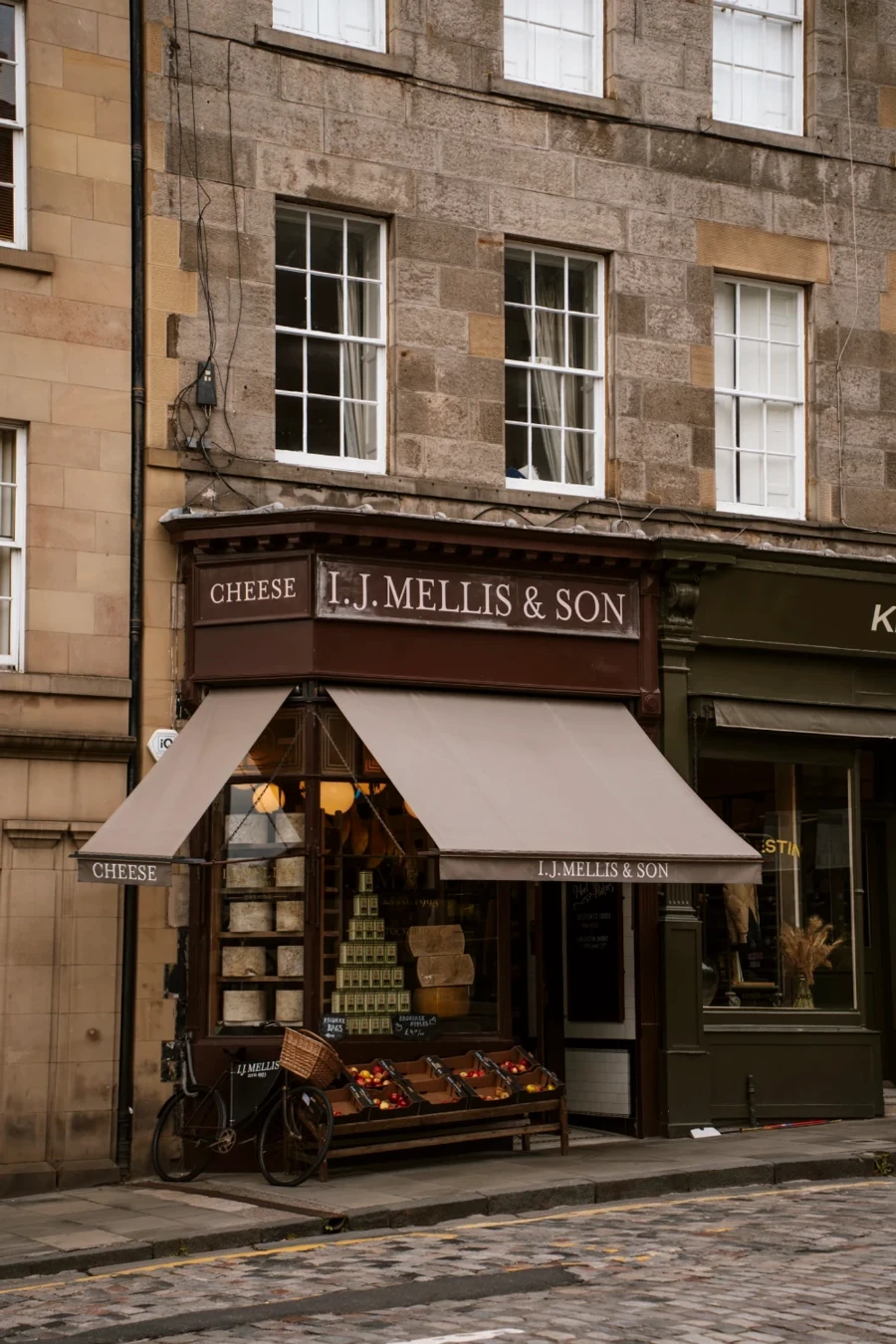 A storefront along the side of a cobble stone road in Edinburgh's Stockbridge neighbourhood