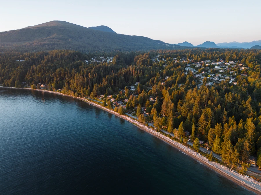 Sunset light illuminating the long stretch of white sand at Bonniebrook Beach near Gibsons, BC