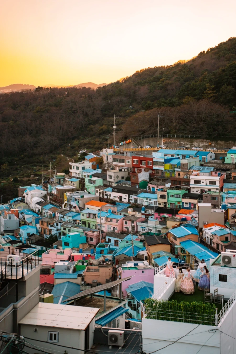 A collection of colorful houses built up along a hillside in Gamcheon Culture Village