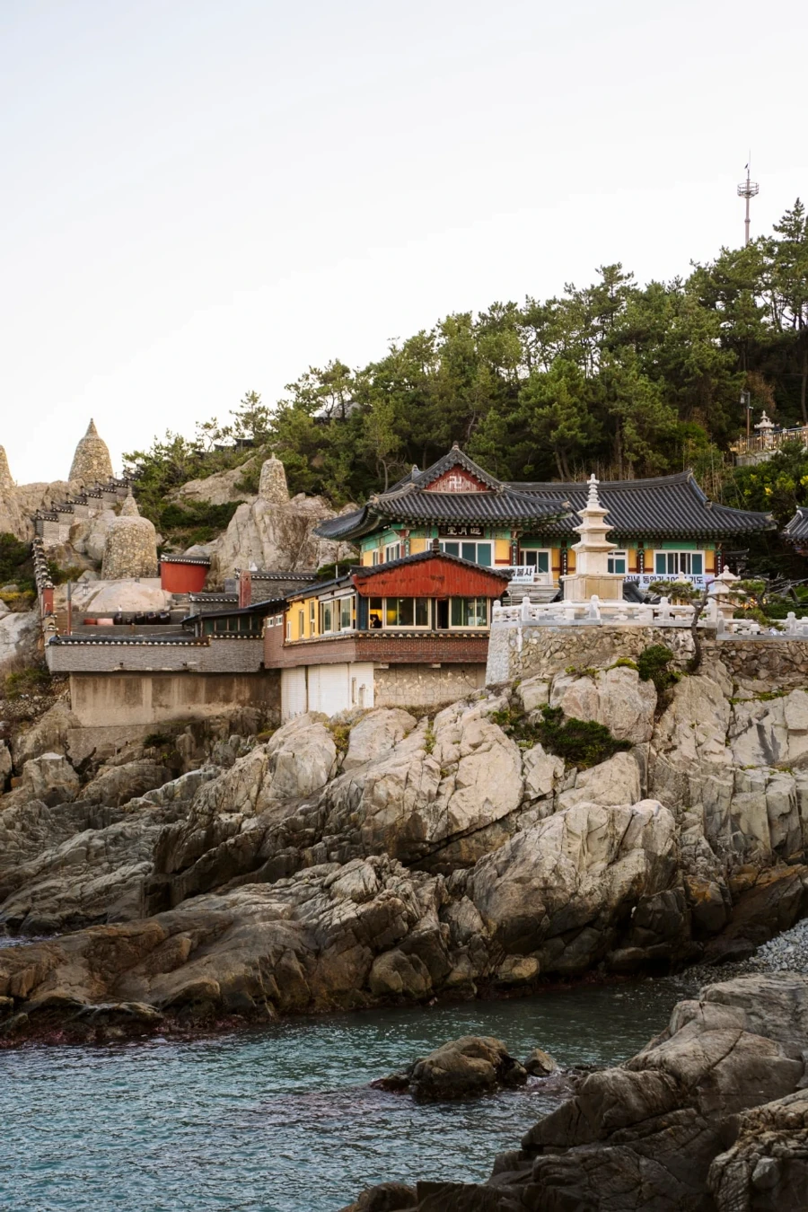 The sea laps at rocks at the base of Haedong Yonggungsa Temple