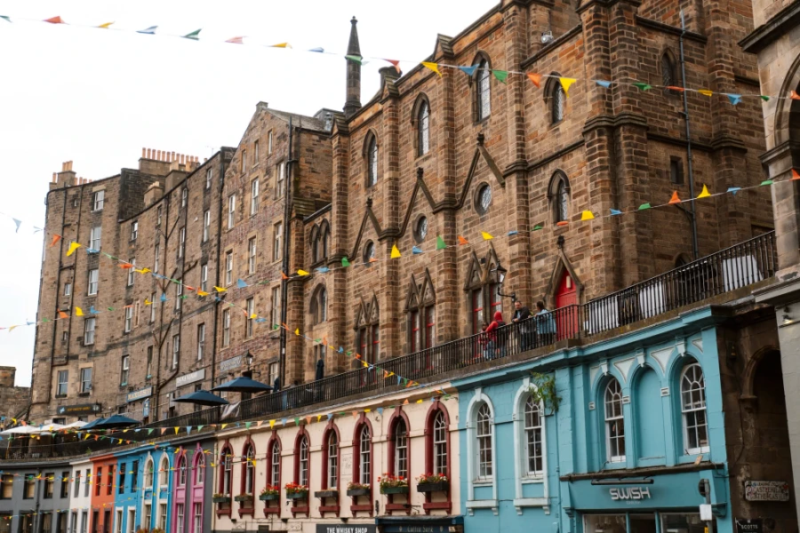 A colourful row of storefronts on Victoria Street in Edinburgh, Scotland