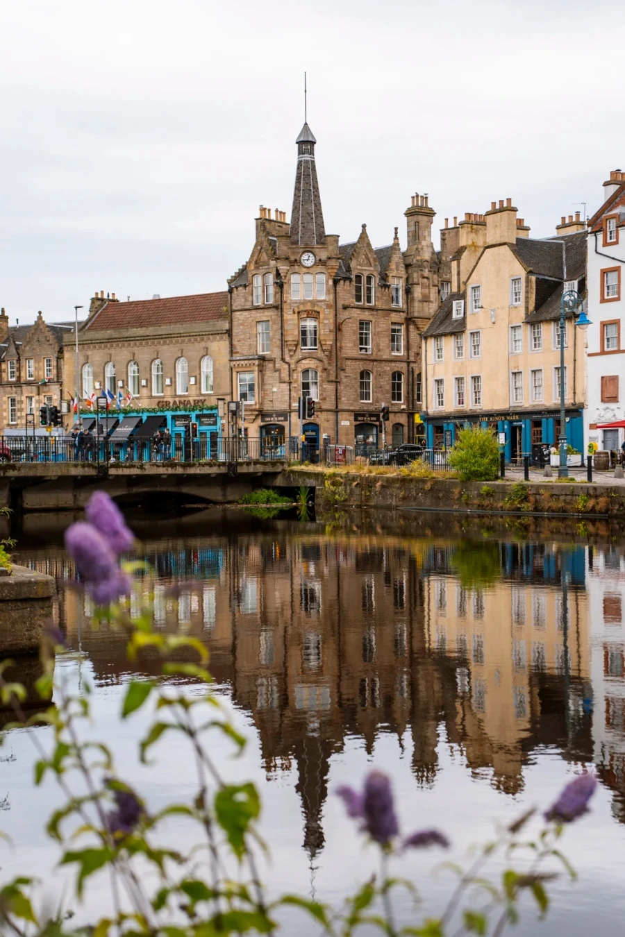 The colorful buildings of Leith are reflected in the calm waters of the canal