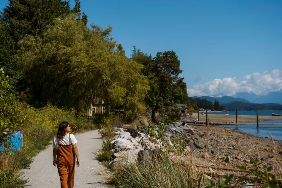 woman walking along a seaside path near Armours Beach on the Sunshine Coast in BC
