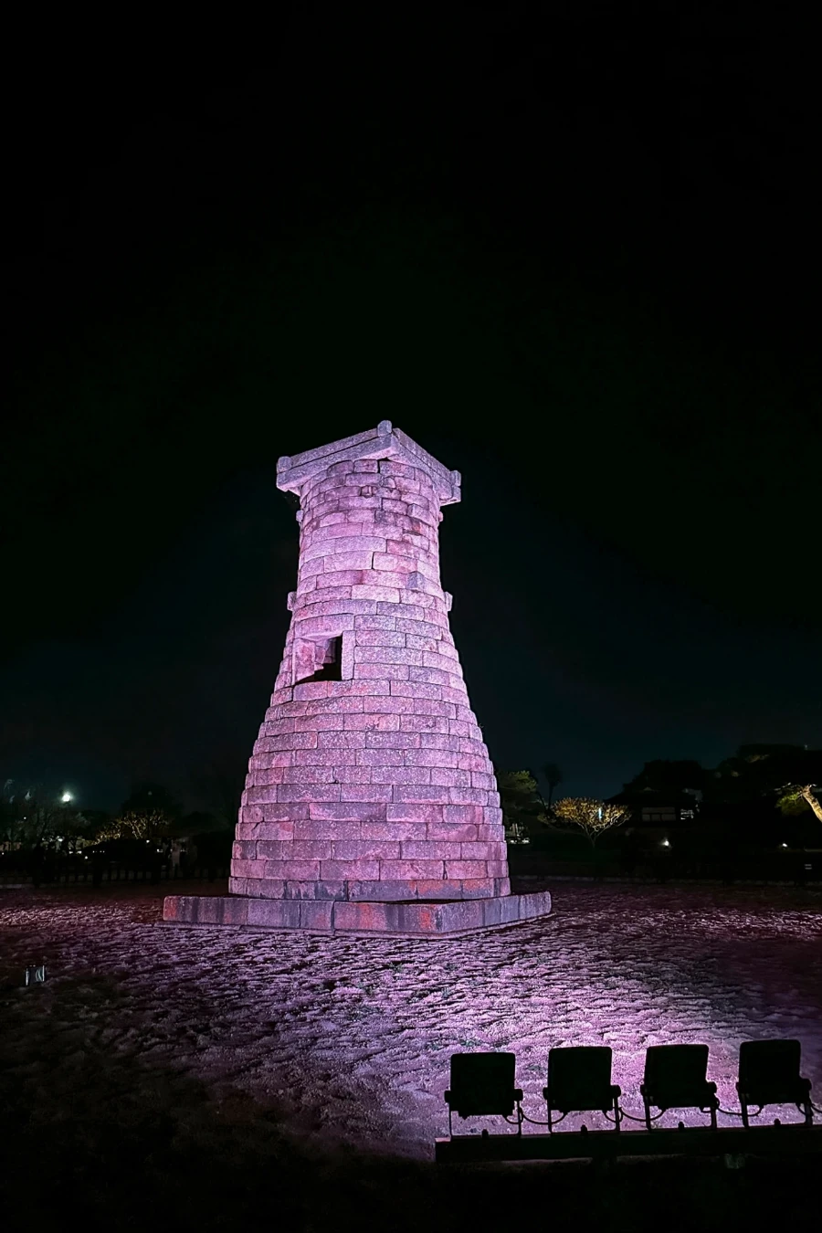 A row of powerful lights illuminate Cheomseongdae Observatory
