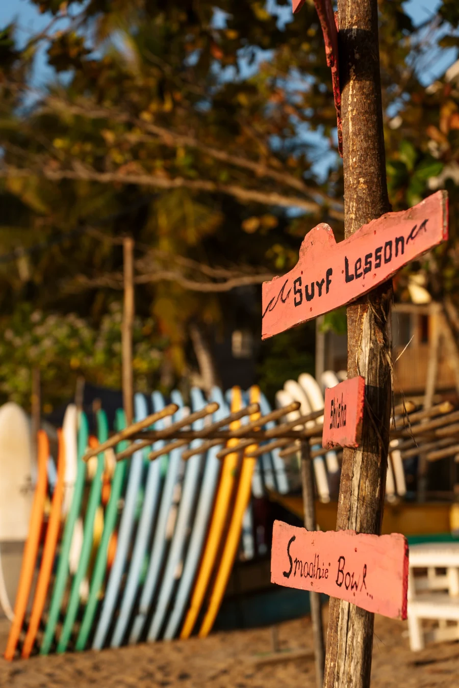 A line of surfboards on the beach near Hiriketiya