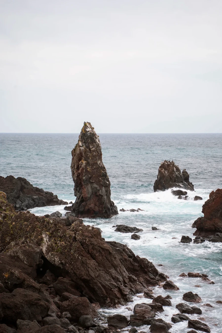Rocky pillars stick out of a choppy sea near the Seopjikoji Coastline Walkway