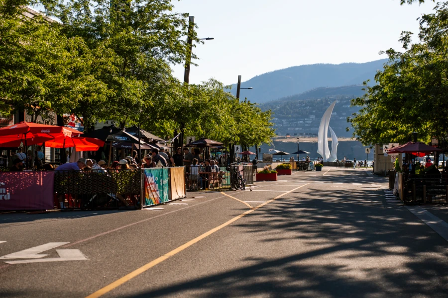 Bernard Street in Kelowna lined with bustling patios filled with people and freckled with multicoloured umbrellas