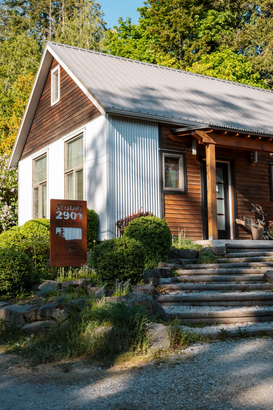 Stairs lead up to a cottage styled art studio with a say beside the steps that reads Studio 2901