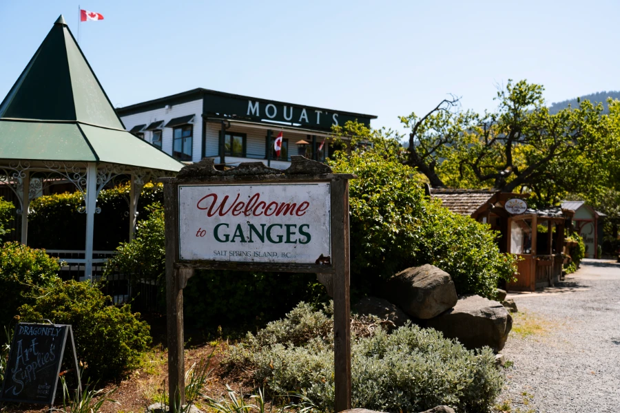 A sign reads 'Welcome to Ganges' with the towns centre behind it