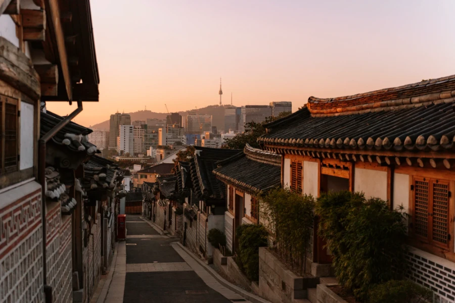 An empty street in Bukchon Hanok Village with Nasam Tower in the distance