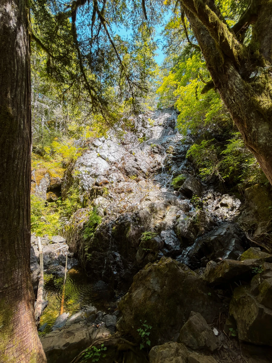 A weak trickle flows down a wide bar rock face