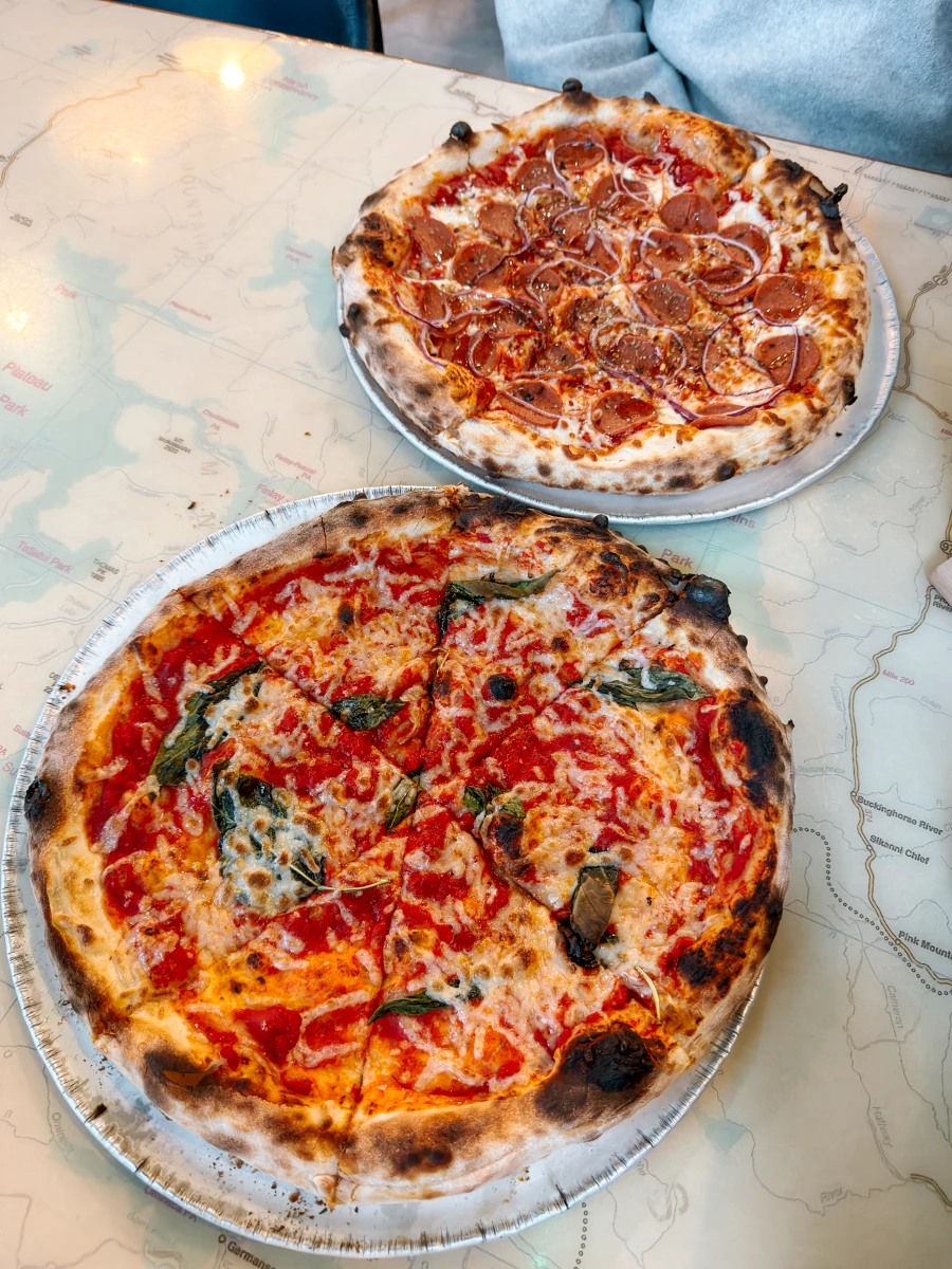 Two wood-fired pizzas on a marble table top at Back Country Brewing in Squamish
