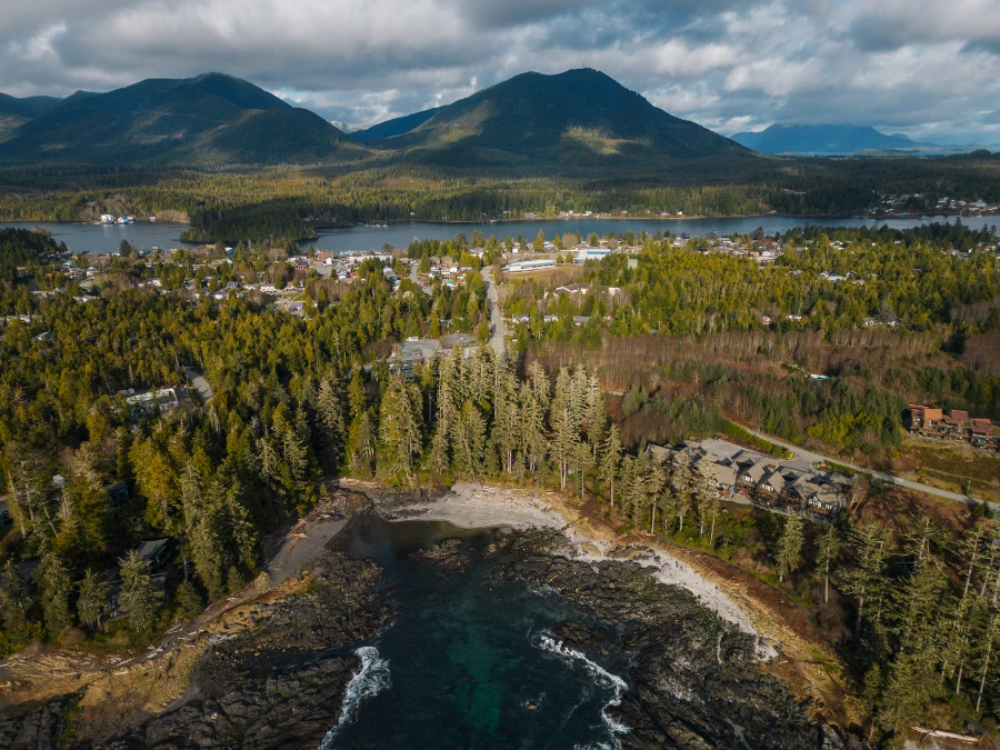 The town of Ucluelet scattered across a forested peninsula surrounded by the Pacific ocean on both sides