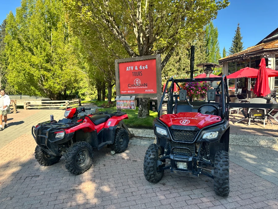 A red ATV and a red side by side parked in the upper Whistler village.