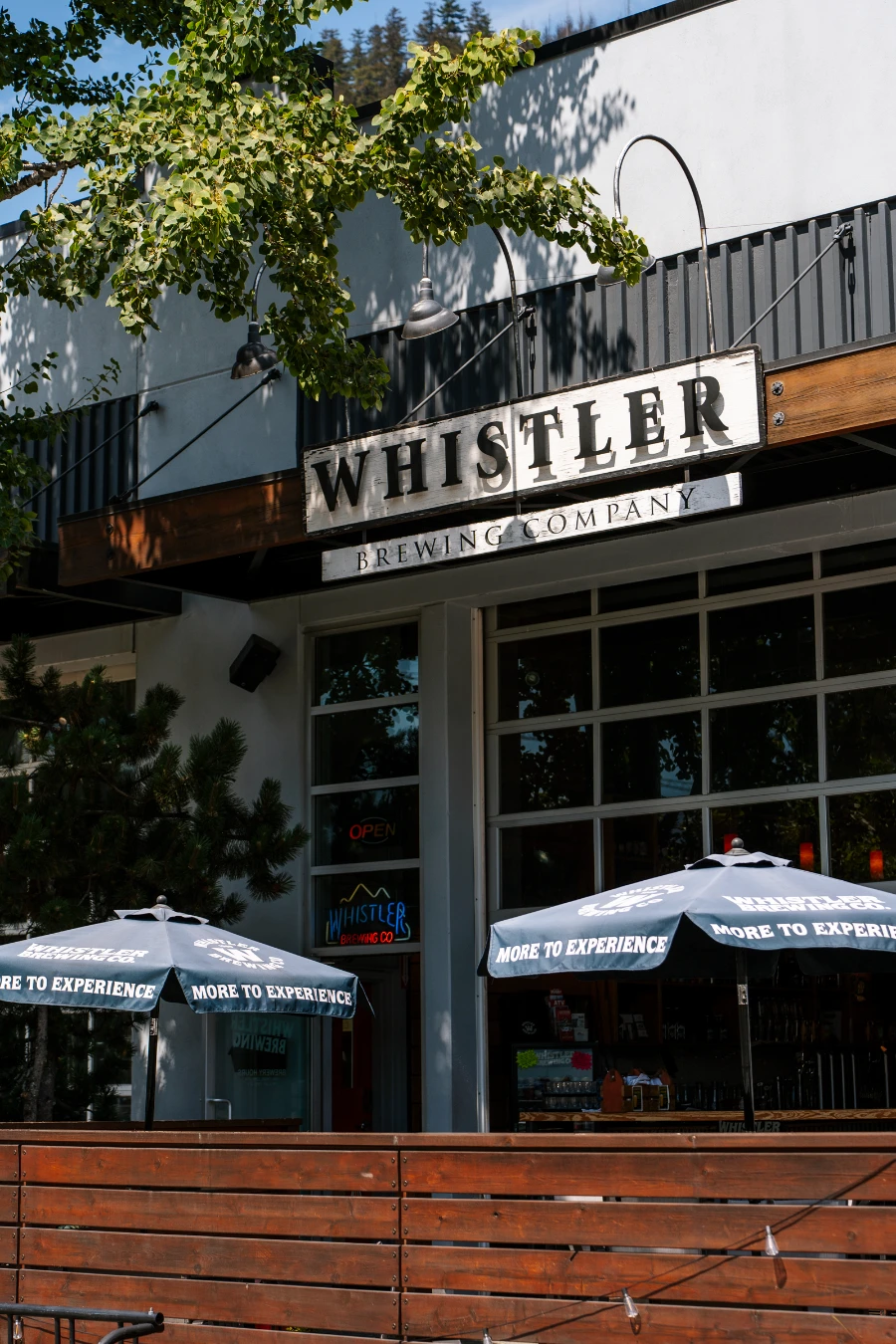 Two umbrellas set up on the patio of Whistler Brewing Company in Function Junction