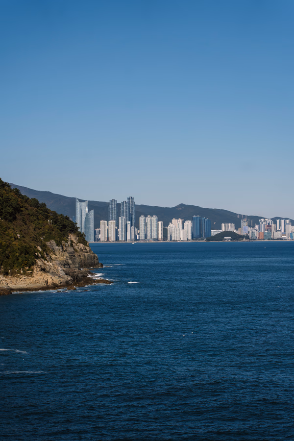 The skyline of Busan across a large stretch of ocean