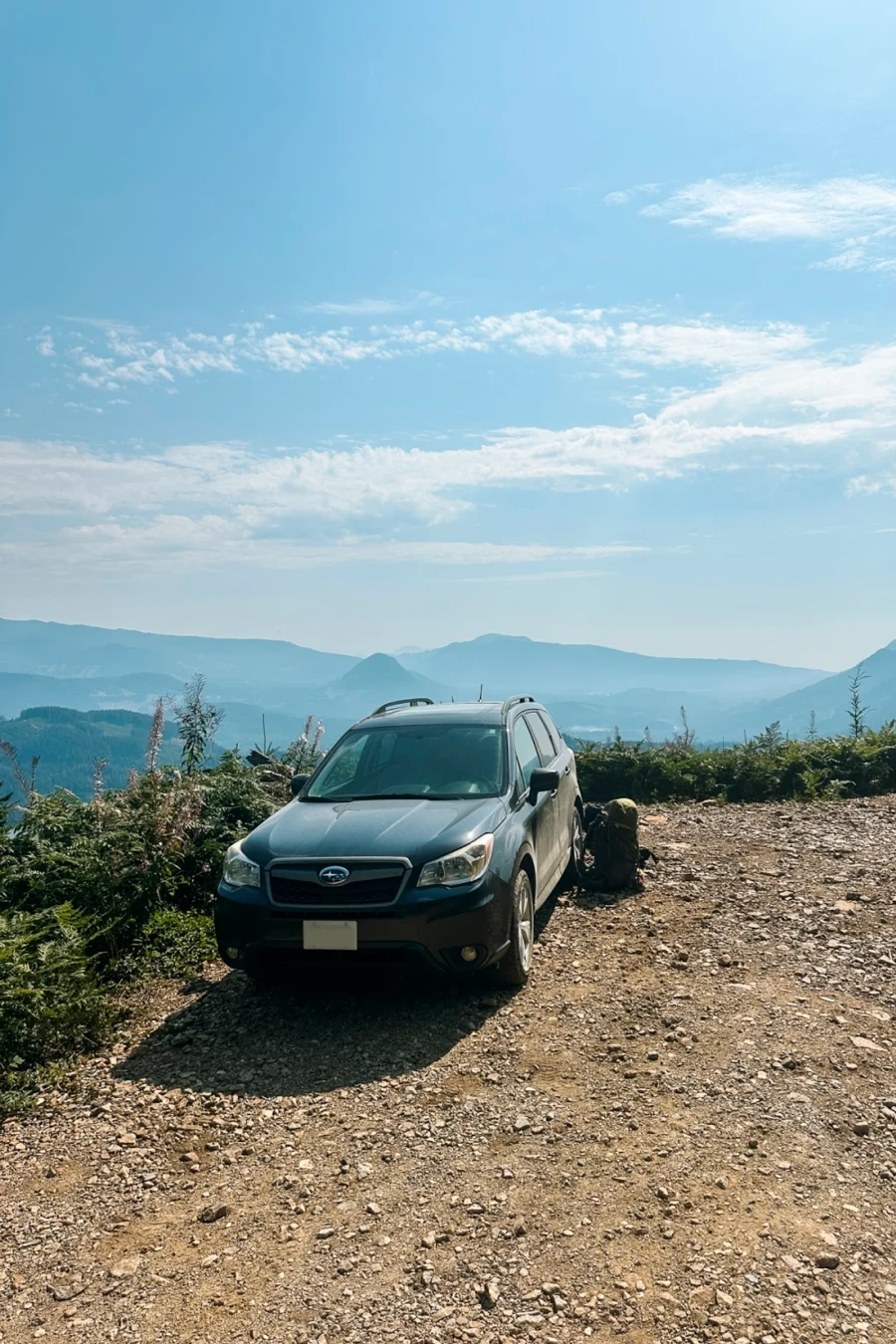 Subaru Forester parked on a gravel service road