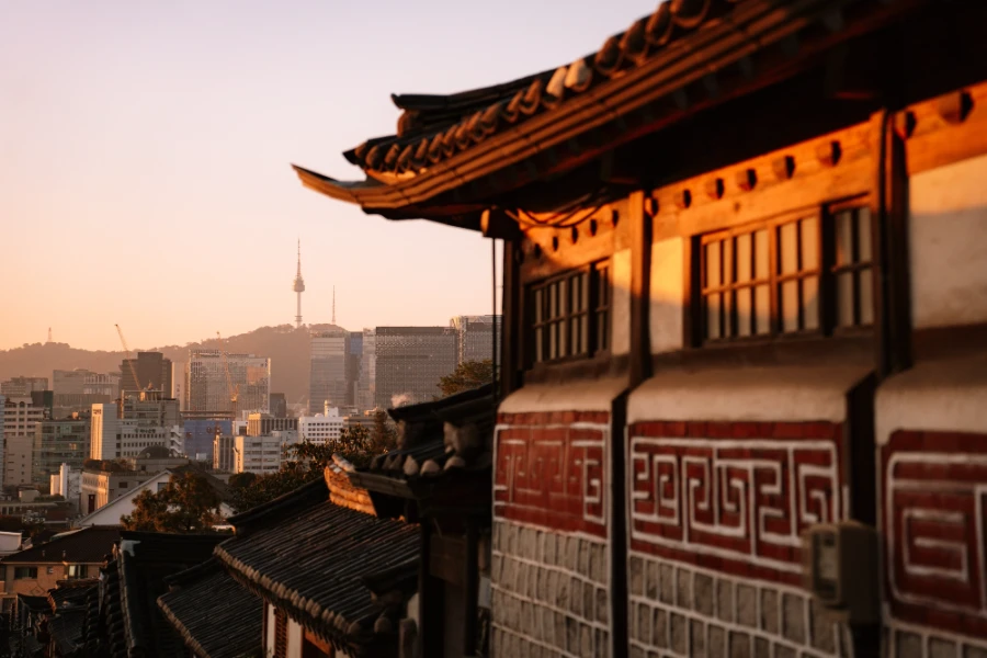 A classic hanok-style building in Seoul, South Korea, frames N Seoul Tower in the morning light, with the more modern skyline visible in the distance Kyoto, Japan