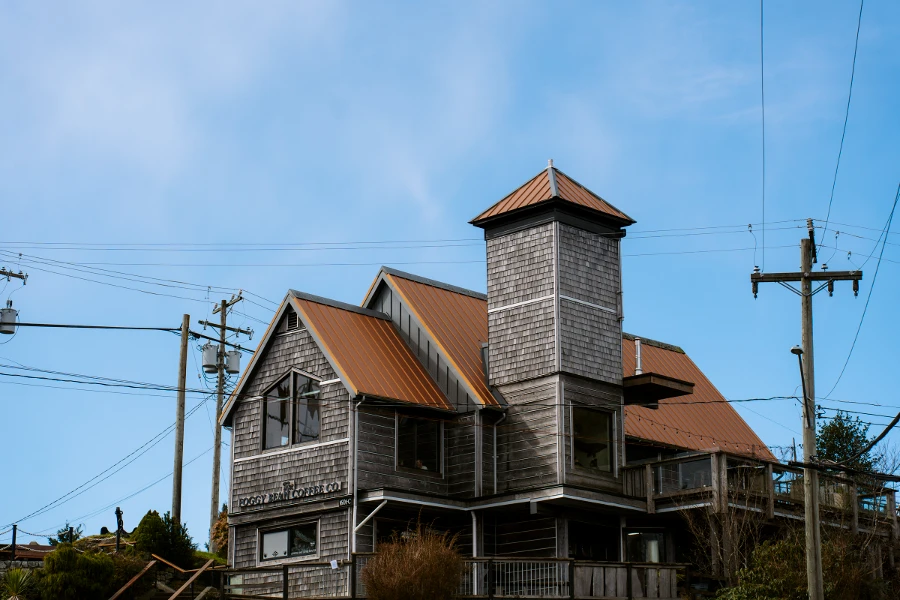 A multi storied tin roofed building is surrounded by power lines in Ucluelet, BC