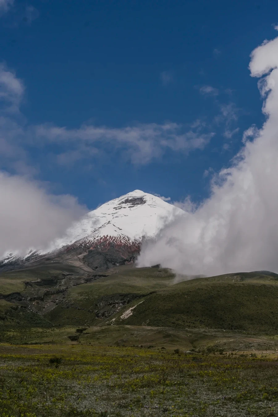 Clouds surround the snowy peak of Cotopaxi Valcano