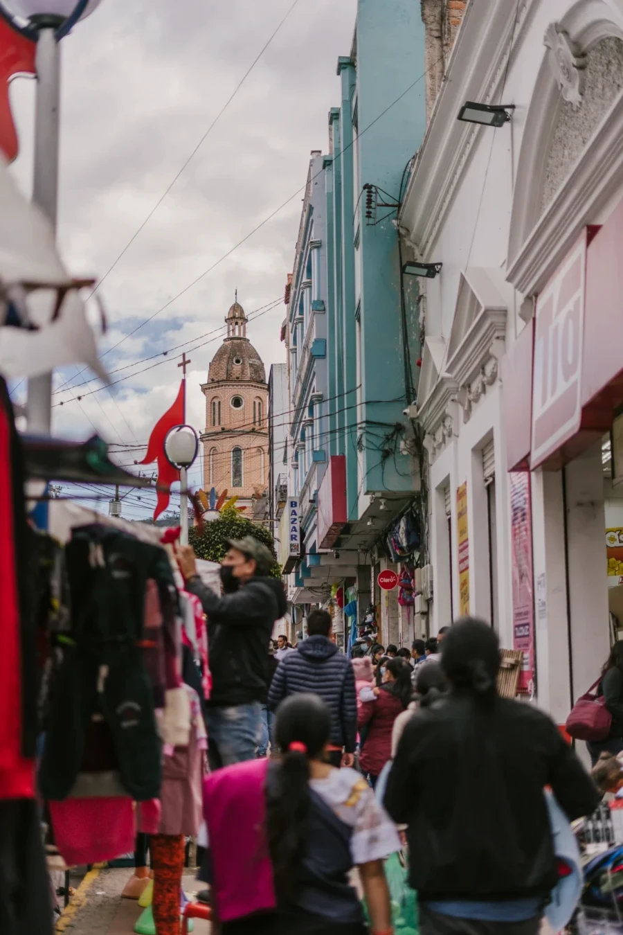 Crowds of people move through a busy market