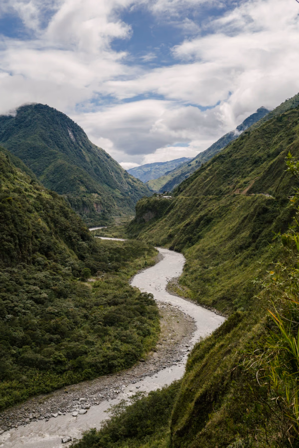 A large river meanders between lush green mountains